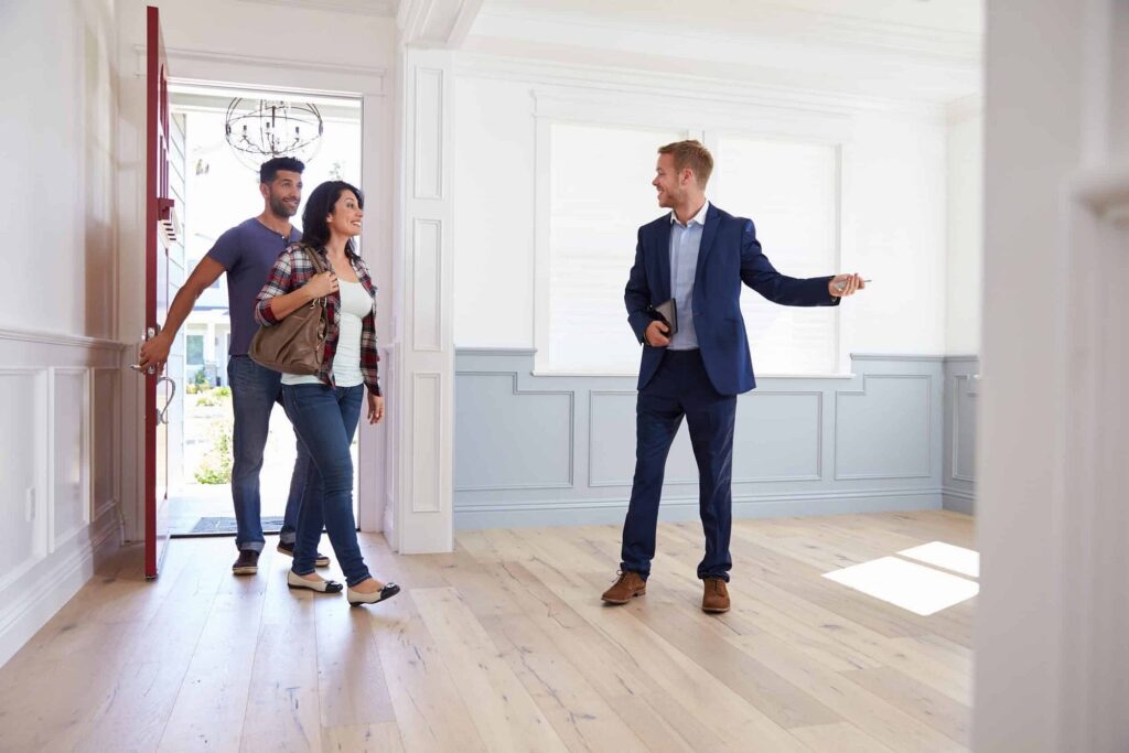 Real estate agent showing a house to a couple, illustrating improved opportunities for home buyers in the Netherlands